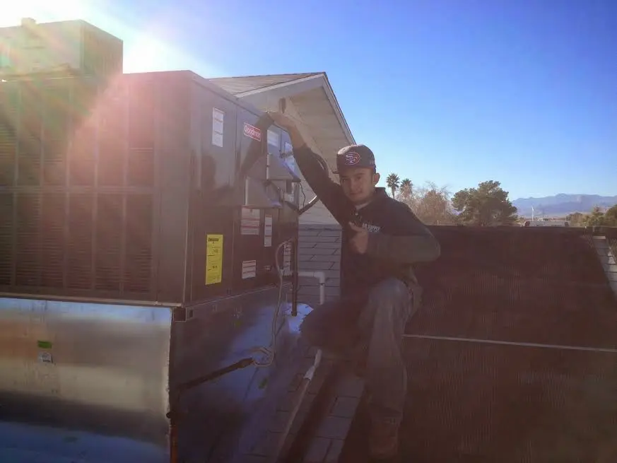 HVAC technician performing Air Duct Cleaning on a rooftop unit in Star